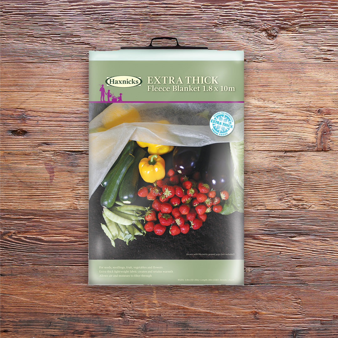 Pack shot Eco Green Garden Fleece Jacket winter plant protection on a wooden background