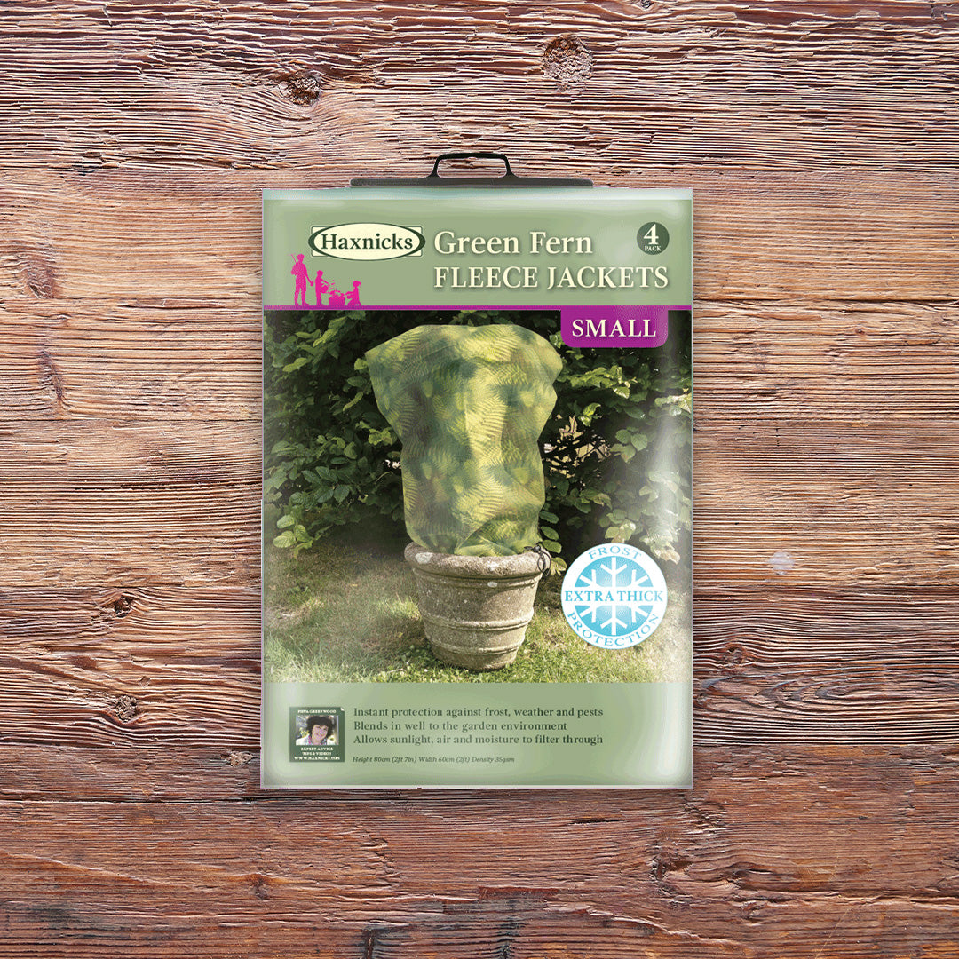 Pack shot Small Green Fern Fleece Jacket winter plant protection on a wooden background