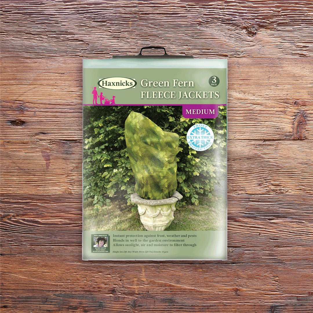 Pack shot Medium Green Fern Fleece Jacket winter plant protection on a wooden background