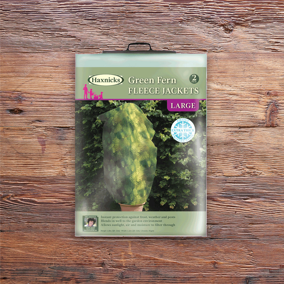 Pack shot Large Green Fern Fleece Jacket winter plant protection on a wooden background