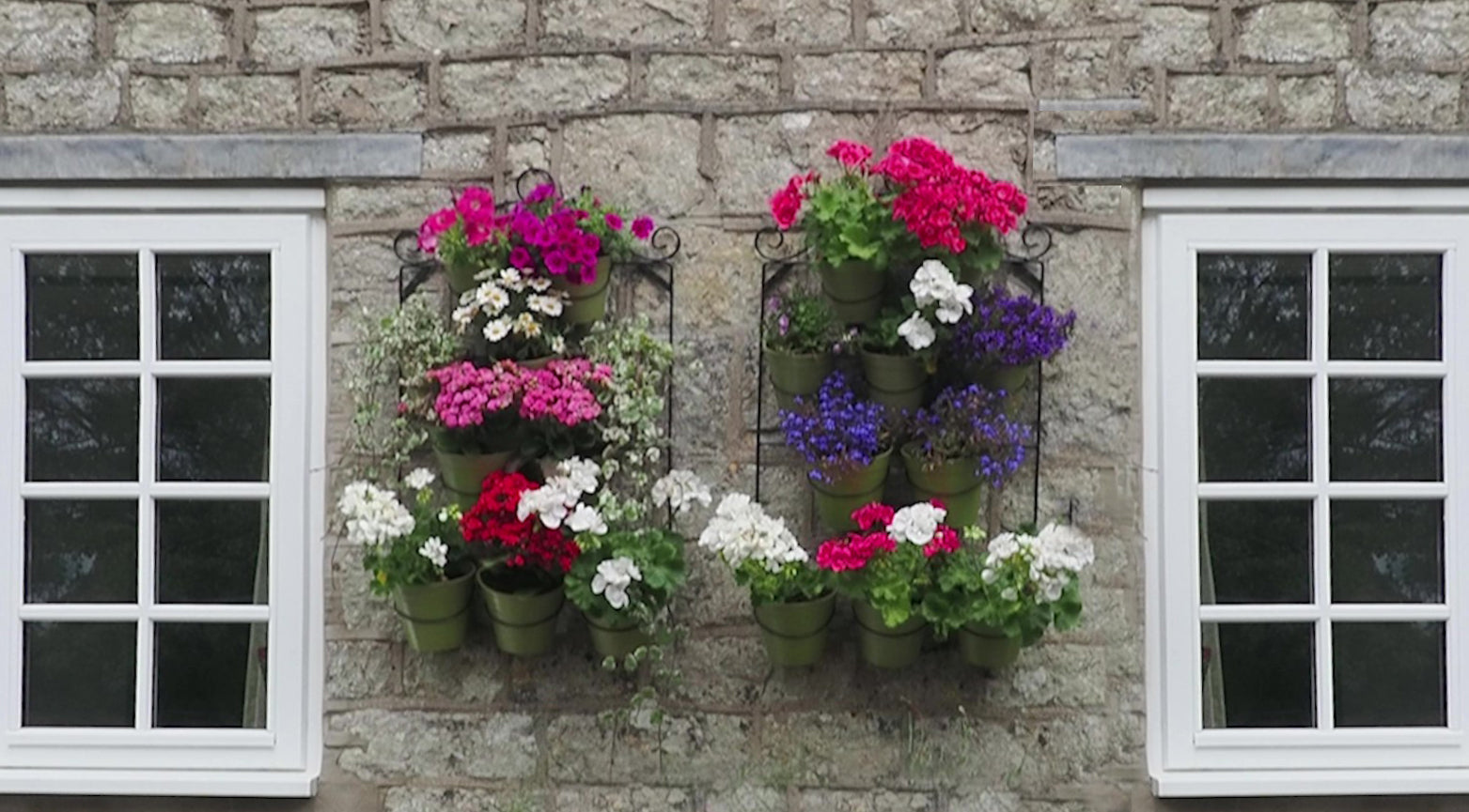 Wall pot holders filled with bamboo pots and flowers